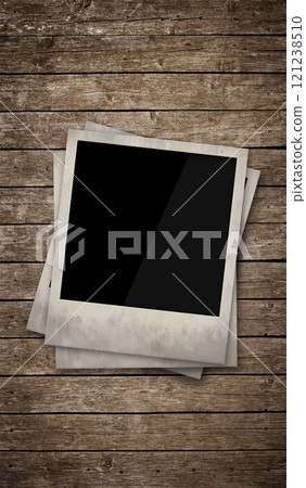 Three empty instant photo frames on wooden table 121238510