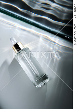 Bottle of face serum with a pipette with a beautiful highlight. 121238644
