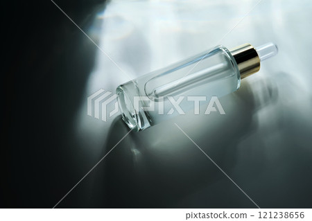 Bottle of face serum with a pipette with a beautiful highlight. 121238656