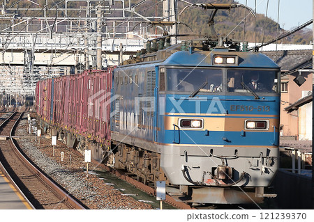 EF510 freight train (No. 513) passing through Shimamoto Station bathed in the setting sun EF510 freight train (No. 513) passing through Shimamoto Station bathed in the setting sun 121239370