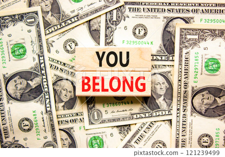 Belonging and you belong symbol. Concept words You belong on beautiful wooden blocks. Dollar bills. Beautiful background from dollar bills. Business belonging and you belong concept. Copy space. Belonging and you belong symbol. Concept words You belong on beautiful wooden blocks. Dollar bills. Beautiful background from dollar bills. Business belonging and you belong concept. Copy space. 121239499