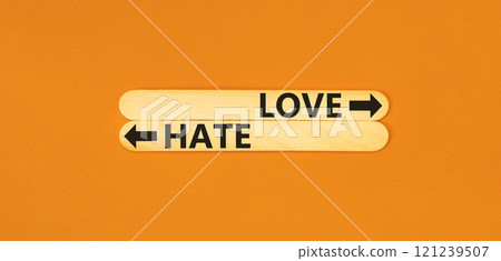 Love or hate symbol. Concept word Love or Hate on beautiful wooden stick. Beautiful orange table orange background. Business and love or hate concept. Copy space. 121239507