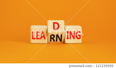 Learning or leading symbol. Concept words Learning Leading on wooden block. Beautiful orange table orange background. Business learning or leading concept. Copy space. Learning or leading symbol. Concept words Learning Leading on wooden block. Beautiful orange table orange background. Business learning or leading concept. Copy space. 121239509