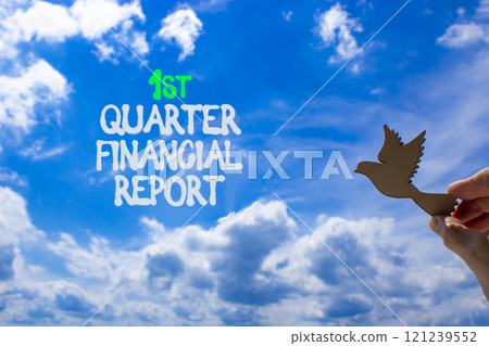 1st quarter financial report symbol. Concept words 1st quarter financial report. Beautiful blue sky and clouds background. Businessman hand. Business 1st quarter financial report concept. Copy space. 121239552