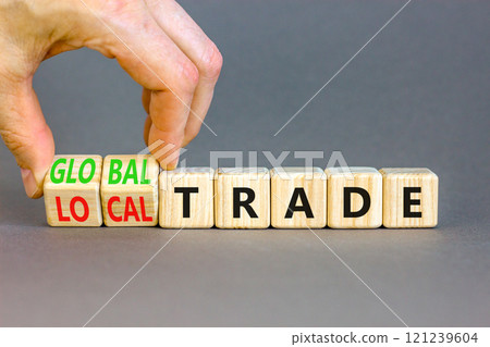 Global or local trade symbol. Concept words Global trade Local trade on beautiful wooden blocks. Beautiful grey background. Businessman hand. Business Global or local trade concept. Copy space 121239604