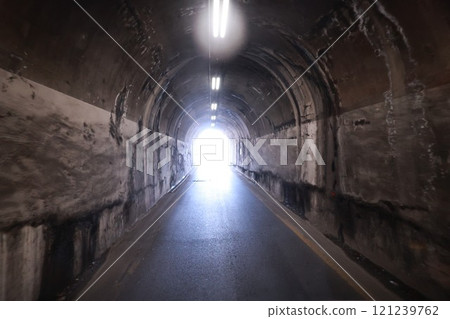 Tunnel with a light shining through it Tunnel with a light shining through it 121239762