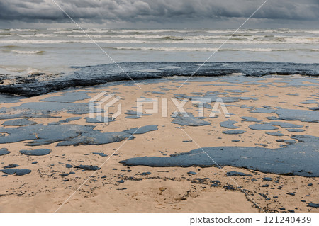 Oil in coastline after a tanker wreck. Fuel oil polluted beach Oil in coastline after a tanker wreck. Fuel oil polluted beach 121240439