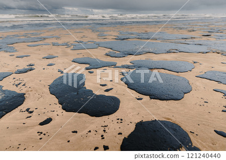 Oil in sea coastline after a tanker wreck. Oil fuel polluted and destroy beach Oil in sea coastline after a tanker wreck. Oil fuel polluted and destroy beach 121240440