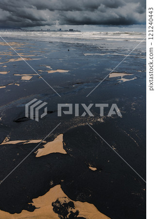 Oil in ocean coastline after a tanker wreck. Oil fuel polluted beach 121240443