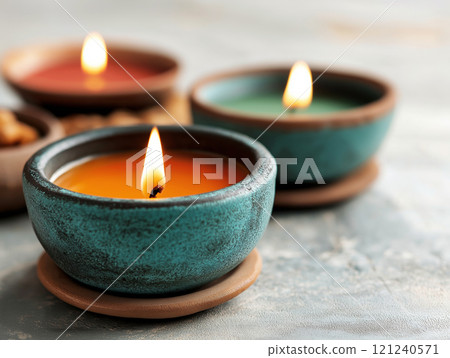 The Festival of Lights. Three candles in small, textured ceramic bowls The Festival of Lights. Three candles in small, textured ceramic bowls 121240571
