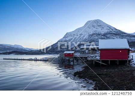 Red cabins at the coast and a mountain, Norway Red cabins at the coast and a mountain, Norway 121240750