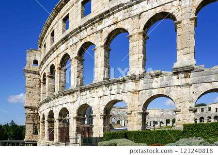 Facade of the ancient ruins of one of the largest preserved Roman amphitheaters in Pula, Istria 121240818