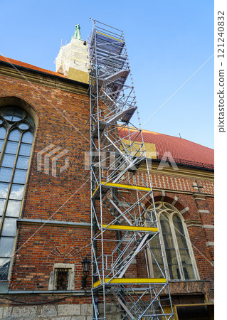 Historic church tower facade restoration using modern very high prefabricated metal tube scaffolding Historic church tower facade restoration using modern very high prefabricated metal tube scaffolding 121240832