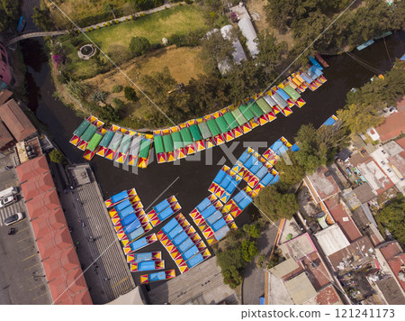 Aerial Drone Shot of Colorful Boats in Xochimilco. Tours by cannels with floating gardens in Mexico City CDMX, Mexico Aerial Drone Shot of Colorful Boats in Xochimilco. Tours by cannels with floating gardens in Mexico City CDMX, Mexico 121241173