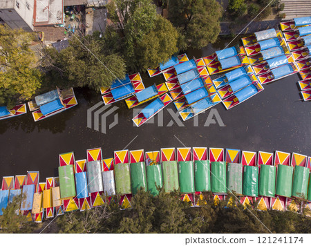 Aerial Drone Shot of Colorful Boats in Xochimilco. Tours by cannels with floating gardens in Mexico City CDMX, Mexico 121241174