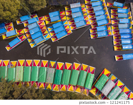 Aerial Drone Shot of Colorful Boats in Xochimilco. Tours by cannels with floating gardens in Mexico City CDMX, Mexico 121241175