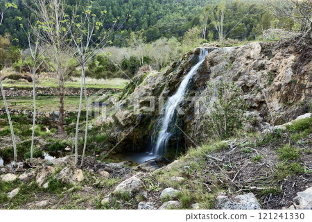 Small waterfalls in a mountain stream on a sunny day 121241330