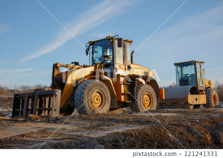 Bulldozer and Roller on Construction Site 121241331