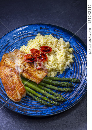 salmon with asparagus and couscous and cherry tomatoes topped with a balsamic vinegar sauce 121242112