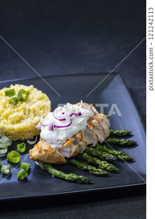 Green asparagus with grilled chicken fillet and couscous Green asparagus with grilled chicken fillet and couscous 121242113