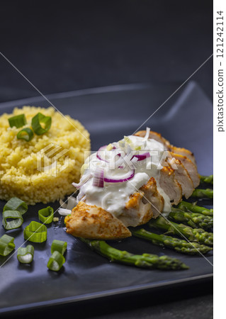 Green asparagus with grilled chicken fillet and couscous Green asparagus with grilled chicken fillet and couscous 121242114