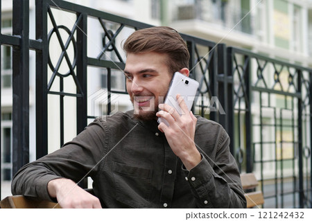 Young businessman talks on smartphone 121242432