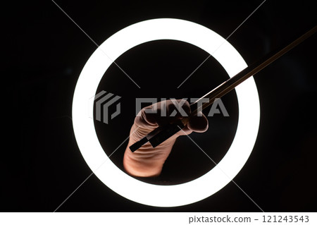 female legs with a violin bow in close-up in a round lamp. the concept of playing the violin .foot fetishism 121243543