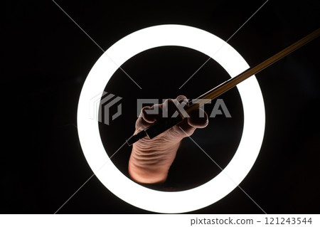 female legs with a violin bow in close-up in a round lamp. the concept of playing the violin .foot fetishism 121243544