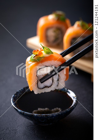 Japanese cuisine. Sushi rolls on a black platter 121244191