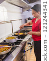 Latin american chef cooking traditional ecuadorian food in madrid restaurant kitchen 121244341