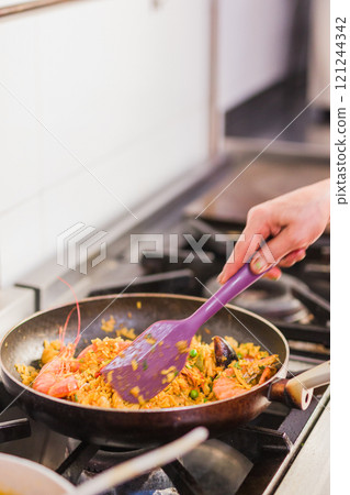 Chef cooking traditional ecuadorian seafood rice dish in madrid restaurant kitchen 121244342