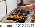 Chef preparing traditional ecuadorian seafood dish in madrid restaurant kitchen 121244343
