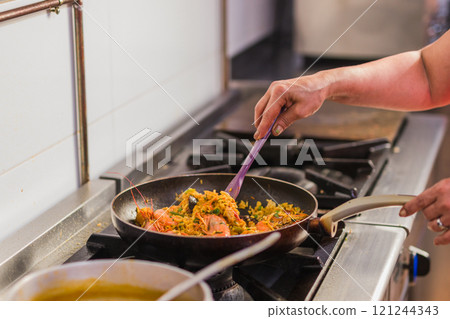 Chef preparing traditional ecuadorian seafood dish in madrid restaurant kitchen Chef preparing traditional ecuadorian seafood dish in madrid restaurant kitchen 121244343