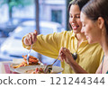 Women enjoying traditional ecuadorian food in madrid restaurant 121244344