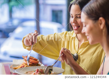 Women enjoying traditional ecuadorian food in madrid restaurant 121244344