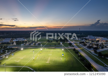 Public sports stadium with young people playing football game at sunset. Active way of life concept Public sports stadium with young people playing football game at sunset. Active way of life concept 121245090