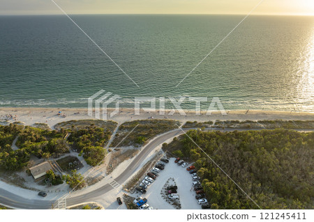 Parking lot at Florida Blind Pass beach on Manasota Key, USA. Vehicle parking area with cars parked on ocean beach parking lot. Summer vacation on beachfront Parking lot at Florida Blind Pass beach on Manasota Key, USA. Vehicle parking area with cars parked on ocean beach parking lot. Summer vacation on beachfront 121245411