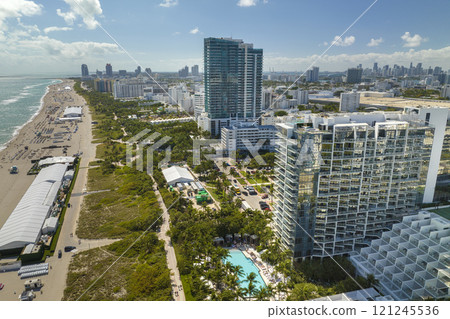 Miami Beach city with high luxury hotels and condos. High angle view of tourist infrastructure in southern Florida, USA Miami Beach city with high luxury hotels and condos. High angle view of tourist infrastructure in southern Florida, USA 121245536