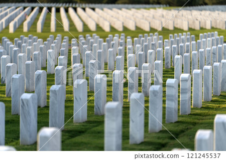 Memorial Day concept. Sarasota National Cemetery with rows of white tomb stones on green grass Memorial Day concept. Sarasota National Cemetery with rows of white tomb stones on green grass 121245537
