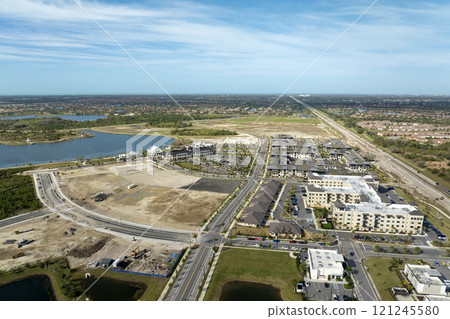 Large development area of residential housing. New suburbs ready for house construction on prepared soil in Florida. Real estate market in the USA Large development area of residential housing. New suburbs ready for house construction on prepared soil in Florida. Real estate market in the USA 121245580