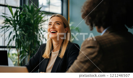 Smiling Caucasian woman at a computer 121246507