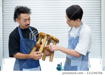 A man making a chair in a workshop A man making a chair in a workshop 121246706