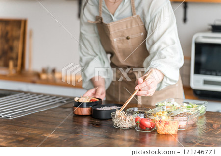Woman's hands making lunch in the kitchen 121246771