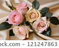 Bouquet of pastel pink roses on gold silk cloth 121247863