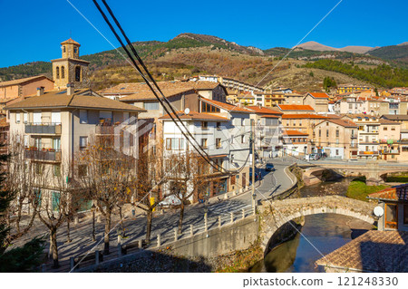 street with river and residential buildings in La Pobla de Lillet in Spain street with river and residential buildings in La Pobla de Lillet in Spain 121248330
