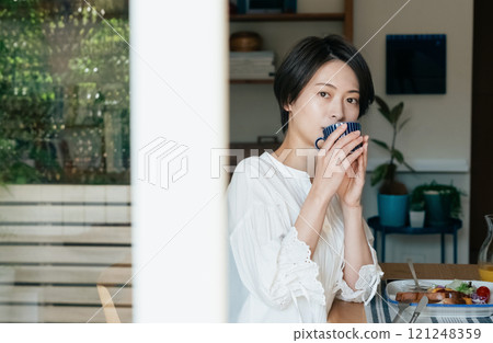 A woman drinking coffee 121248359