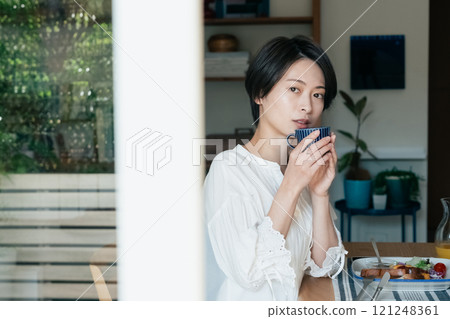 A woman drinking coffee 121248361