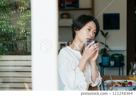 A woman drinking coffee 121248364