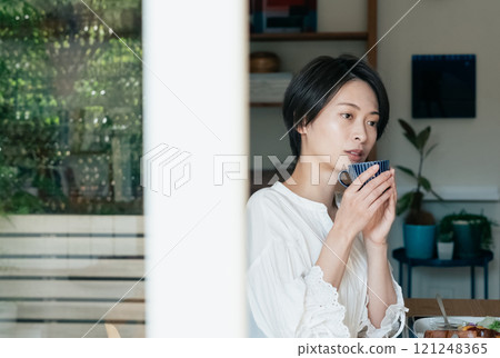 A woman drinking coffee 121248365