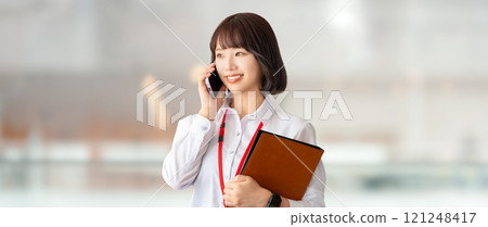 Smiling woman/businesswoman talking on smartphone Smiling woman/businesswoman talking on smartphone 121248417